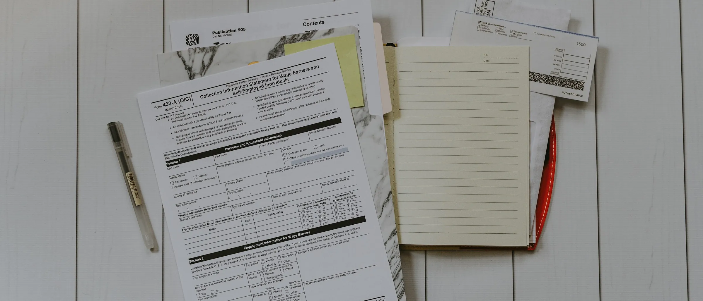 A stack of paperwork laid flat, the backlog before it is rebuilt