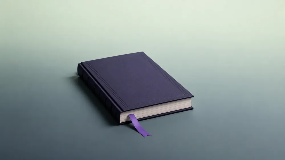 A closed ledger with a violet marker ribbon, marking Vigor's accounting and bookkeeping articles