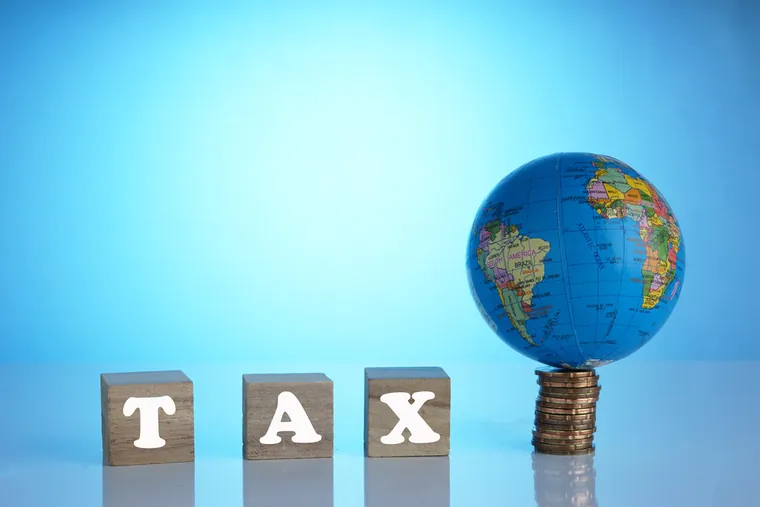 VAT and corporate tax concept image illustrating DMTT 15 Percent Sharjah: What Businesses Must Understand